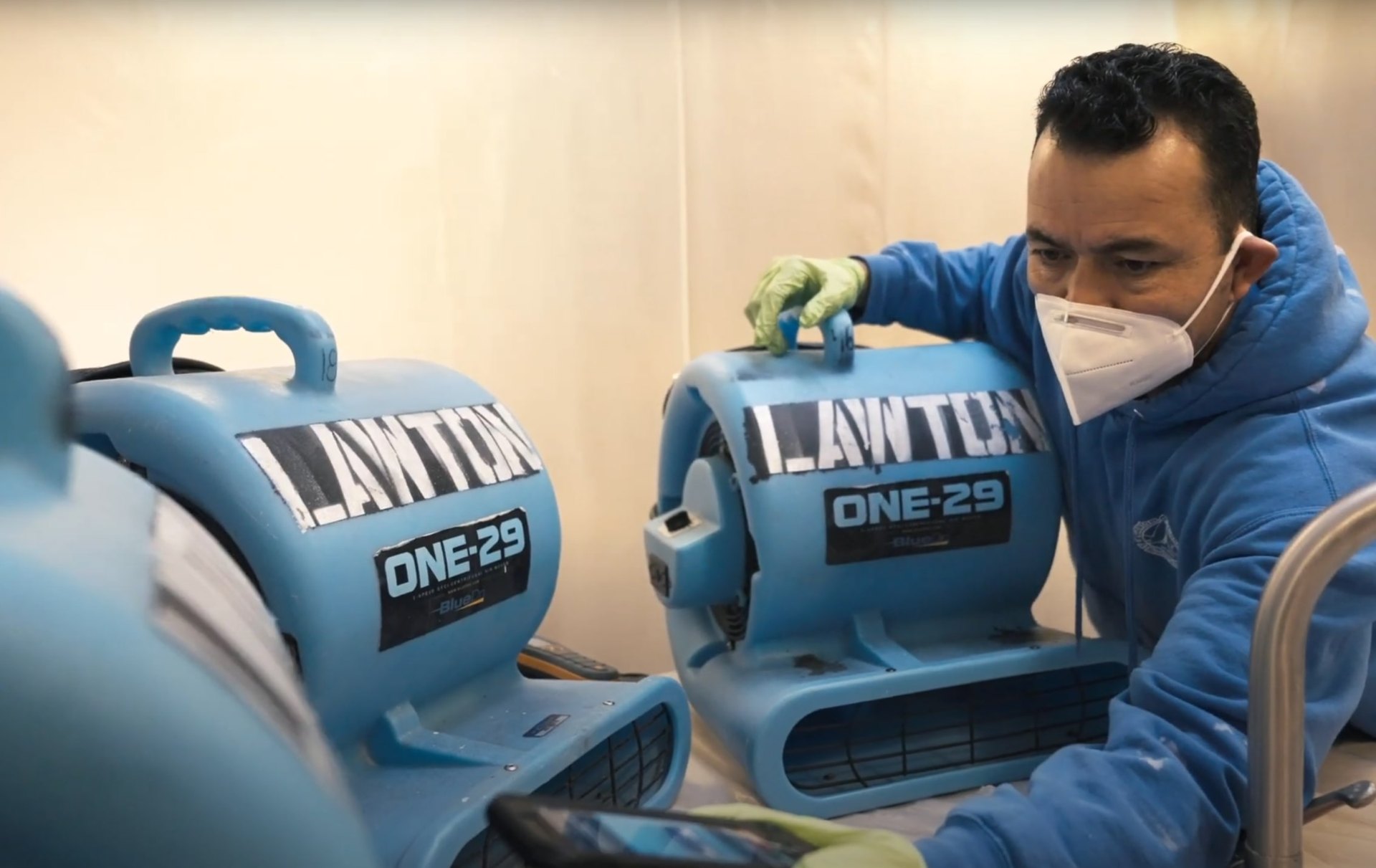 Water damage restoration equipment and professional service Professional water damage restoration technician using advanced drying equipment