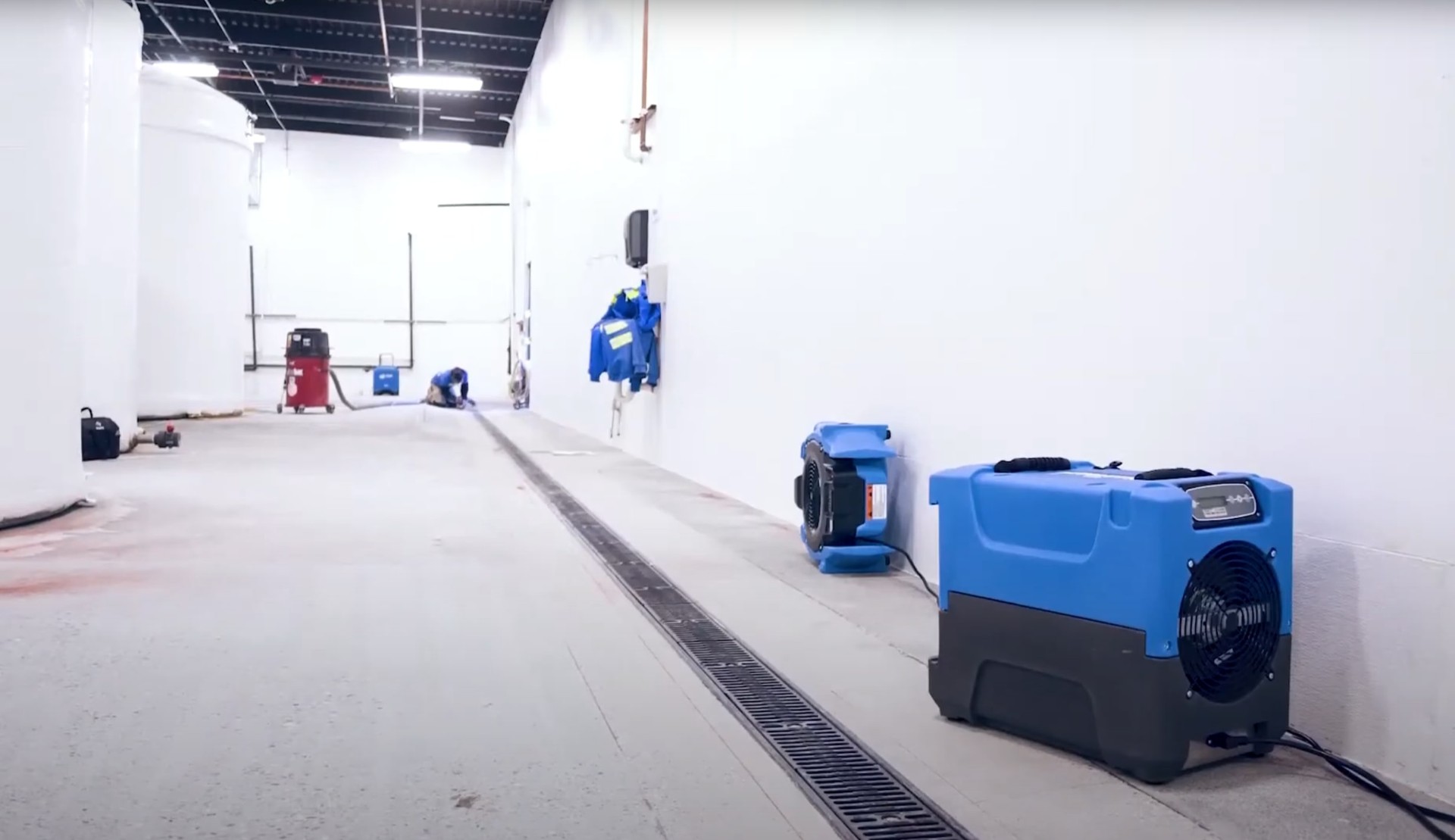 Professional water damage restoration equipment in large commercial facility Large-scale water damage restoration in commercial space with industrial equipment